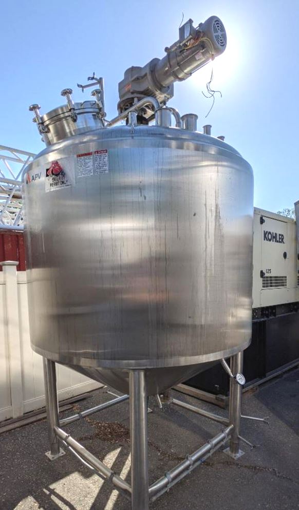 ***SOLD*** used 1000 Gallon APV Jacketed Processor / Kettle with Sweep Mixer Scrape surface agitation. Shell is 316L Stainless Steel . Jacket Rated 110 PSI @ 350 Deg.F.. S/N K-2449.  Dome top. 18 in. dia. top manway, full sweep, 3 HP Explosion Proof (XP) motor into gear box. Stationary baffle, dual spray balls. Top ports: (1) 18 in. dia. manway, (4) 4 in. sanitary fitting ports, (4) 2 in. sanitary fitting ports, (1) 1.5 in. sanitary fitting port, Side ports: (1) 2 in. sanitary fitting port, Bottom ports: (2) 1 in. female thread ports, (1) center discharge 3.5 in. flange fitting port, Discharge height 25.5 in., Jacket ports: (8) 2 in. flange fitting ports (6 on side, 2 on bottom), adjustable legs, USDA Model CCA, (4) picking eyes. Overall dimensions: 87 in. long x 77 in. wide x 142 in. tall. Last used in Sanitary Food Plant. Jacket Hydro-tested good. (1000 gallon; 3785 Liter)