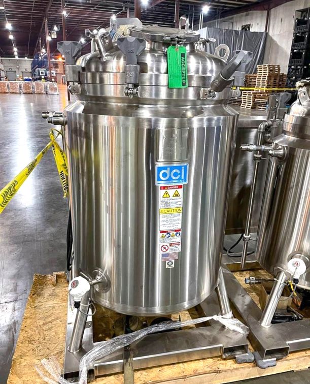 UNUSED DCI 350 Liter (92 Gallon) Sanitary Reactor/Fermenter with Top mounted 5 HP Agitation. Internal Rated 45/Full Vacuum PSI @ 225 Deg.F..  Jacket rated 150/FV @ 225 Deg.F.. Mounted on Skid with Control Panel with Temp and Mixer control. NB# 11221. S/N JS7103. 